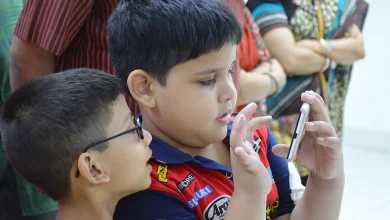 Two boys looking at a smartphone together, illustrating children and mobile platforms