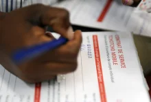A person completing a mobile banking form on a smartphone