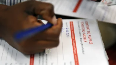 A person completing a mobile banking form on a smartphone